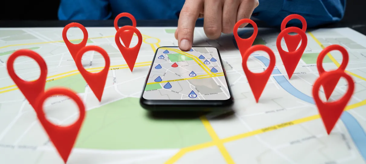 what are local service ads? red location pins on map surrounding a phone with a GPS pulled up