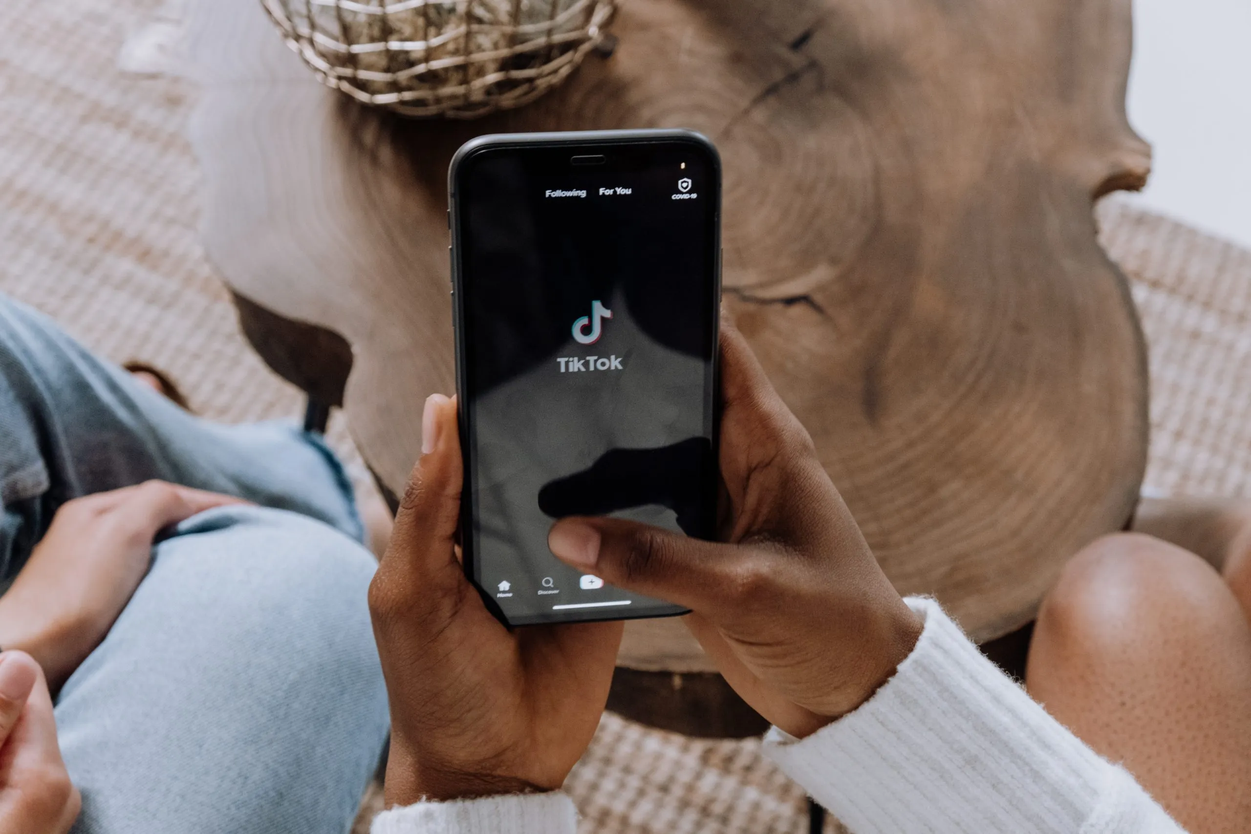 woman using phone to look at tiktok