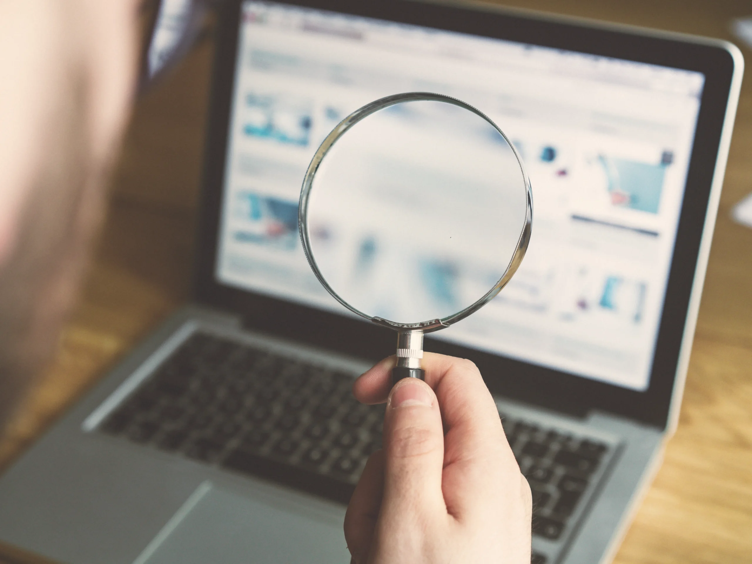 magnifying glass on a computer - indicating the use of image optimization