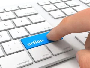 hand pressing an "action" key on a keyboard to imply reaction to a call-to-action