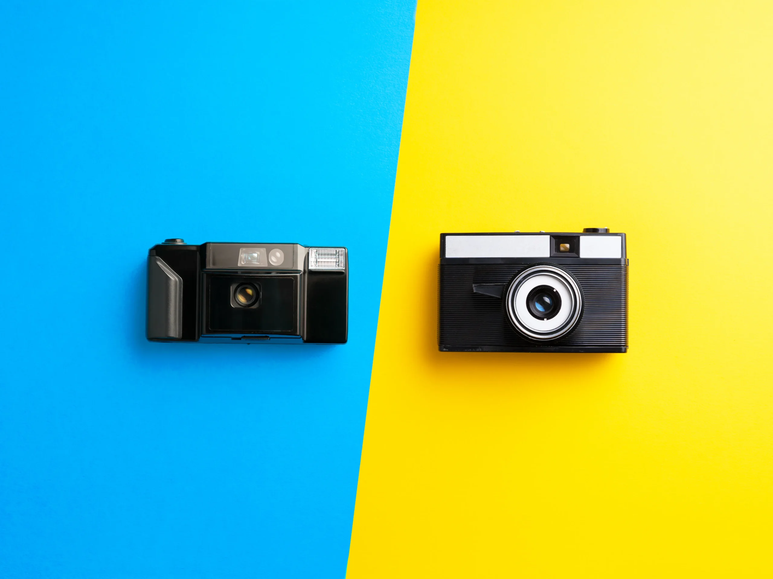 different cameras laying on colors to indicate the importance of color for photography in marketing