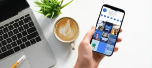 person holding phone with Corkboard Concepts' instagram on it understanding the instagram algorithm