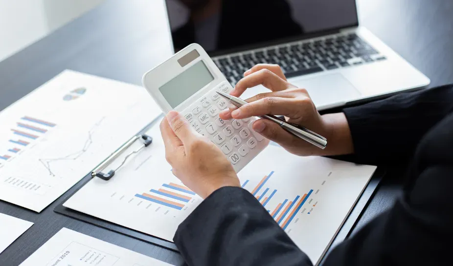 person checking their business's budget with a calculator
