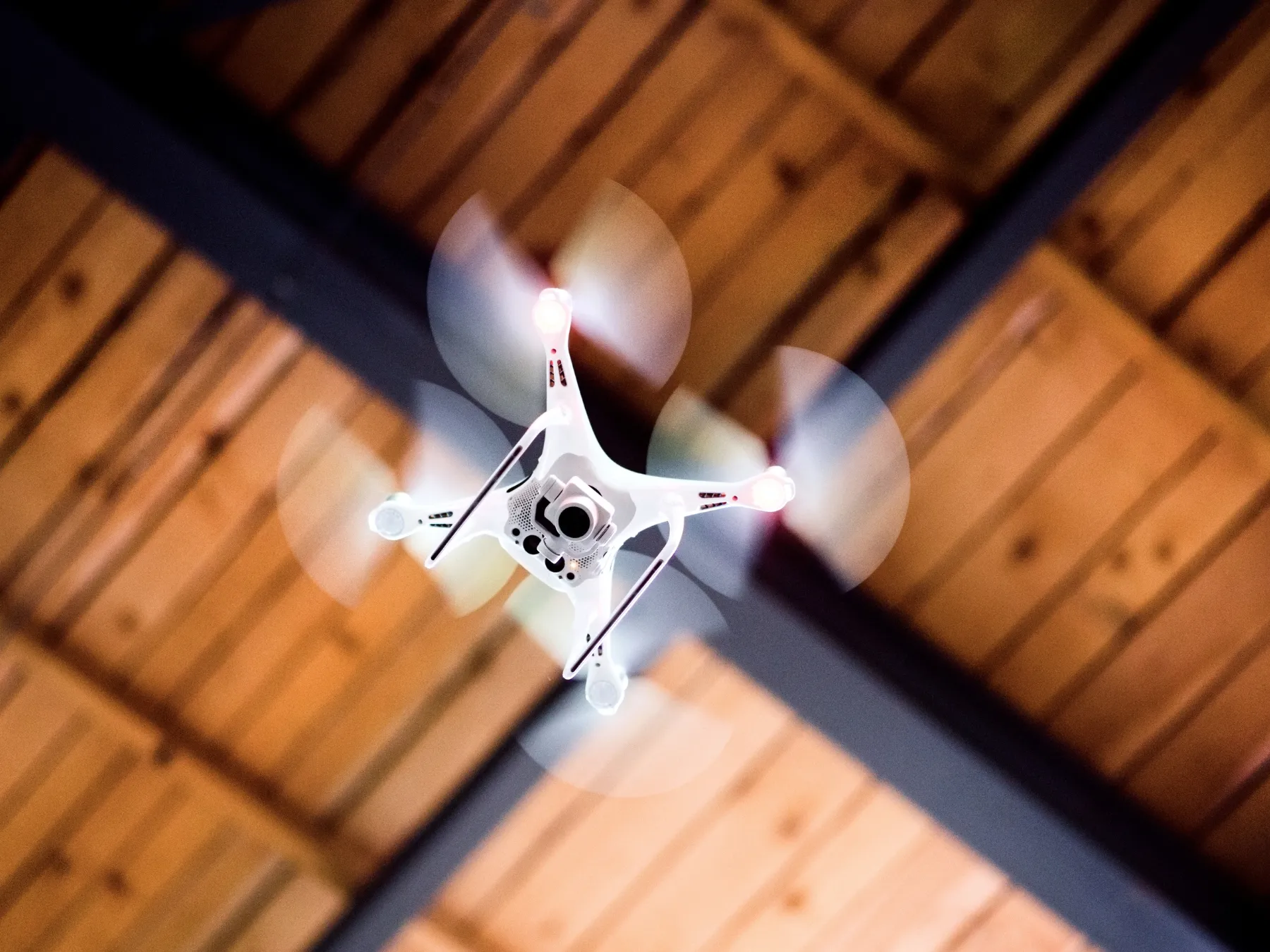 white drone flying in a building