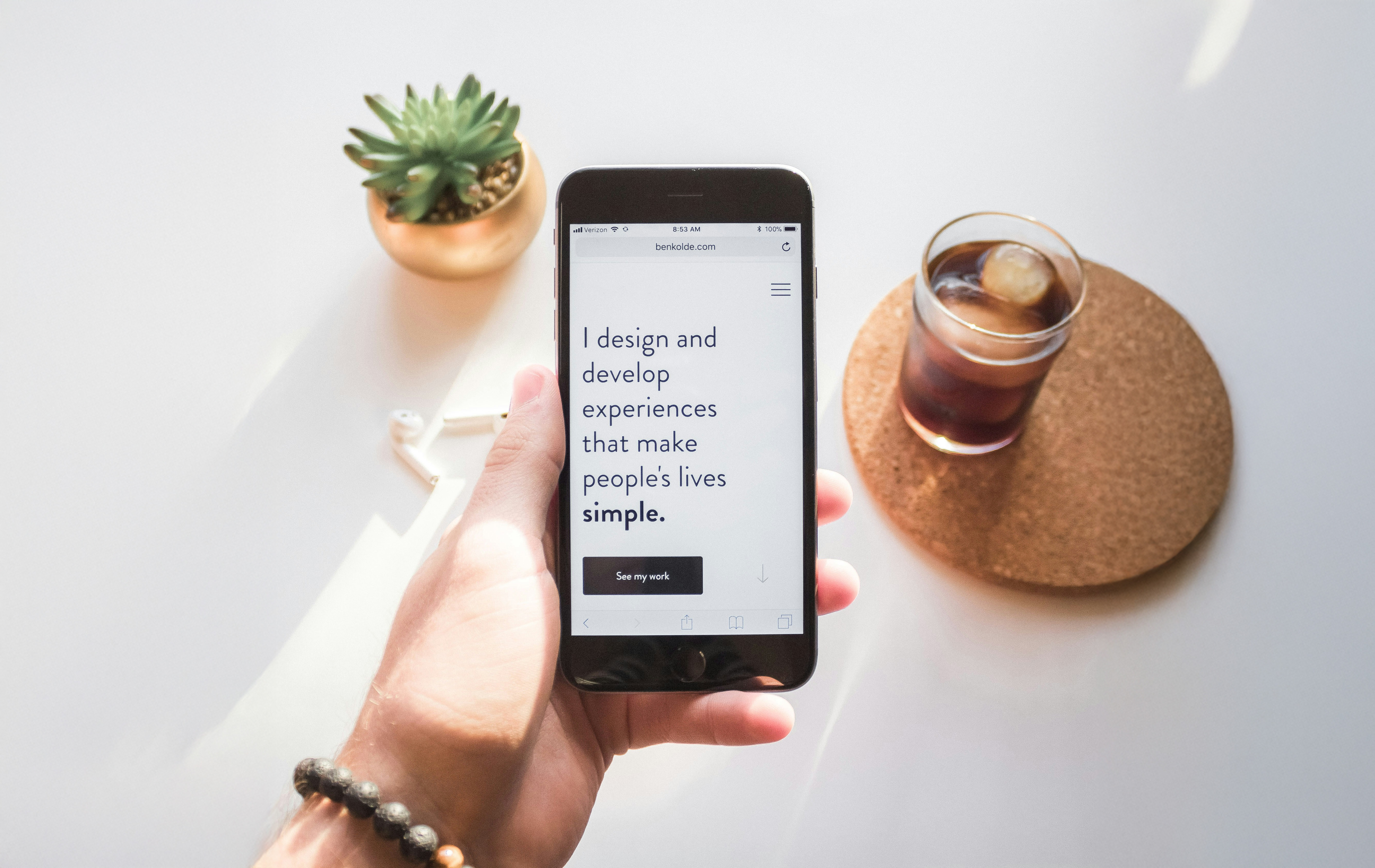 Person holding phone looking at a website