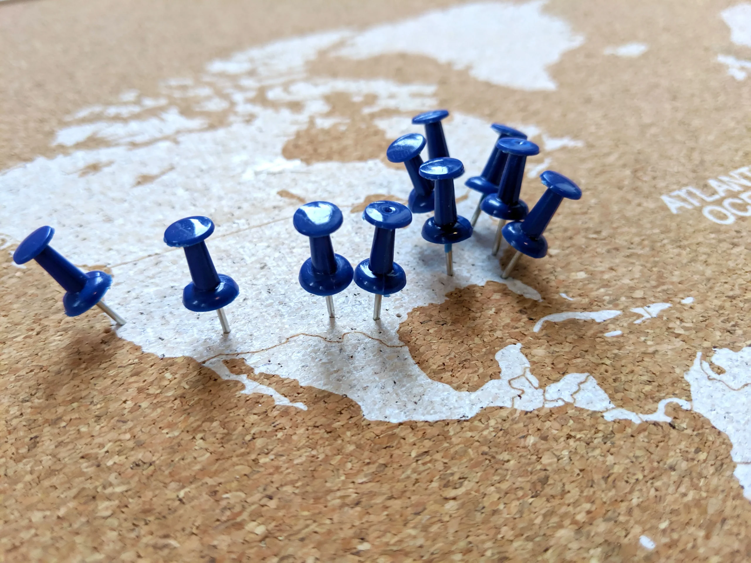 how corkboard concepts crafts a data-driven marketing strategy blog cover: blue thumb tacks on a corkboard with a map of the usa